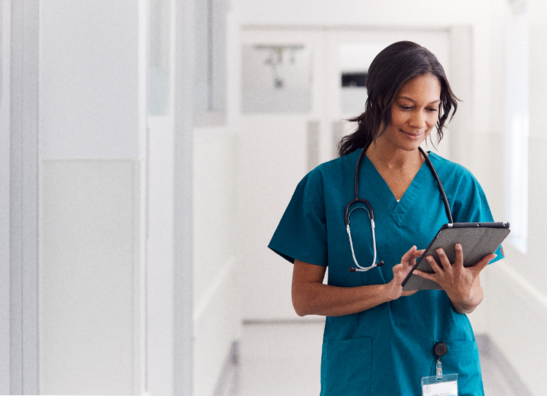 Healthcare worker holding digital tablet and stethoscope hanging from shoulders