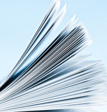 Stack of bound paper containing printed text